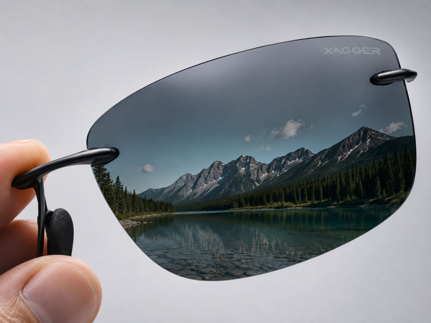 A XAGGER polarized lens held up, a crisp mountain lake seen clearly through it