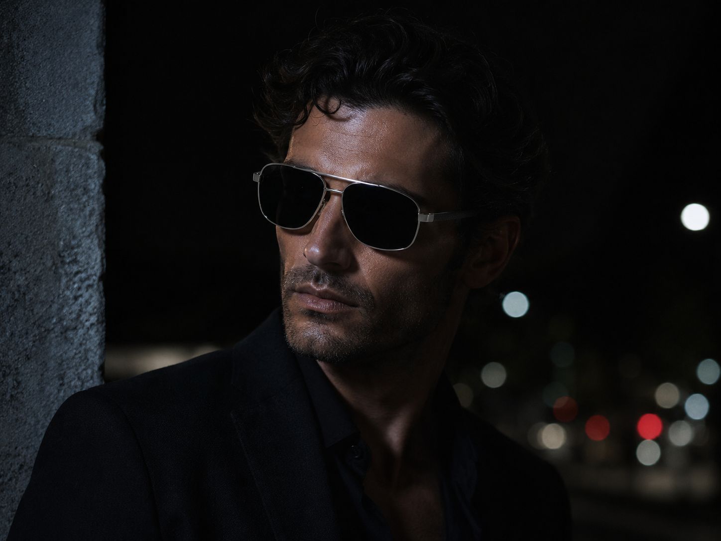 A man at night in the city wearing the XAGGER Brow Bar Aviator